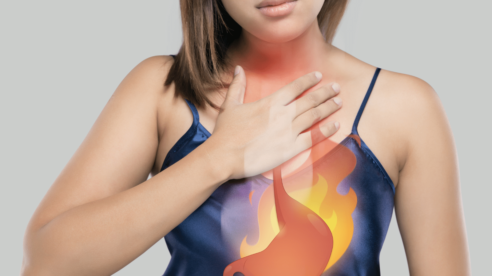 When Should You See an ENT for Acid Reflux? Feature Image: Woman with her hand to her chest